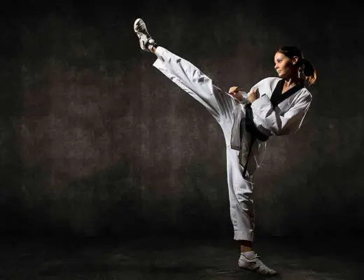 female kicking in a taekwondo uniform
