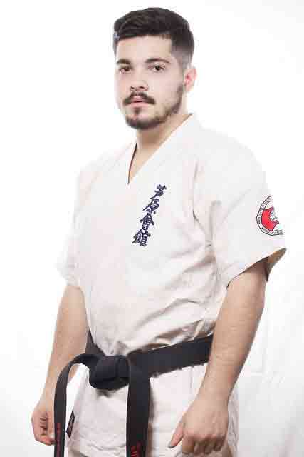 guy in karate uniform with a black belt in karate